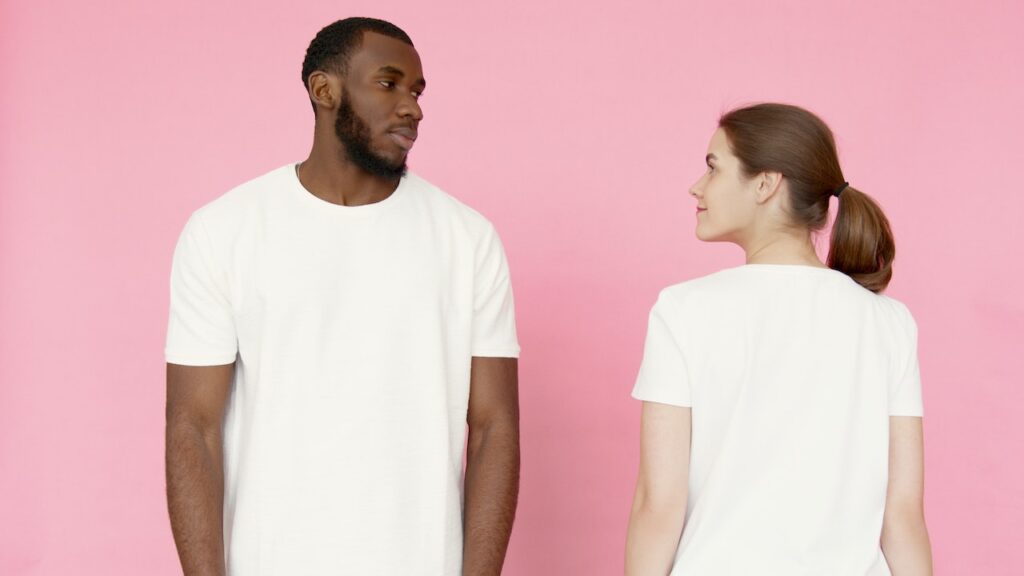 men and women wearing a comfortable white cotton t-shirt paired with denim jeans, showcasing the versatility of AirGarb's premium cotton tees. The shirt is breathable, hypoallergenic, and perfect for everyday wear