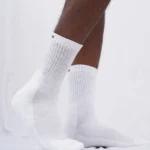 A trio of comfortable white crew length cotton socks designed for both men and women, featuring cushioning for enhanced comfort, from Air Garb.