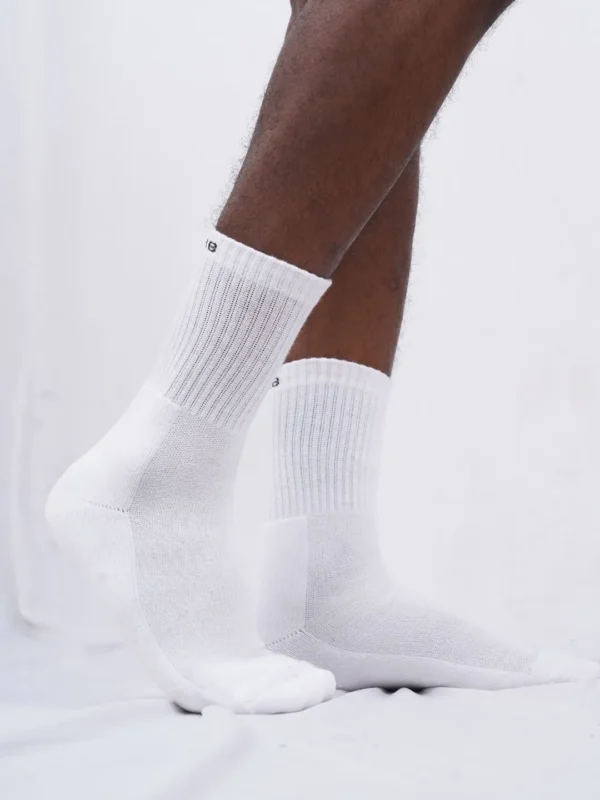 A trio of comfortable white crew length cotton socks designed for both men and women, featuring cushioning for enhanced comfort, from Air Garb.