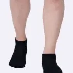 Pair of low ankle socks in a neutral color, designed to cover the foot and ankle for comfort and breathability.